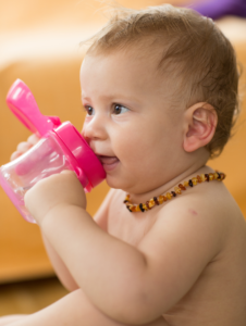baby toddler wearing amber teeth pain relief necklace